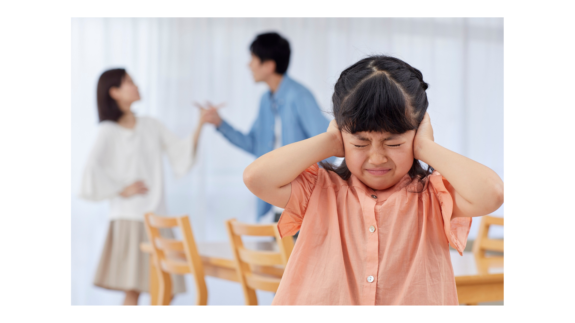 Child covering hears during parents fight